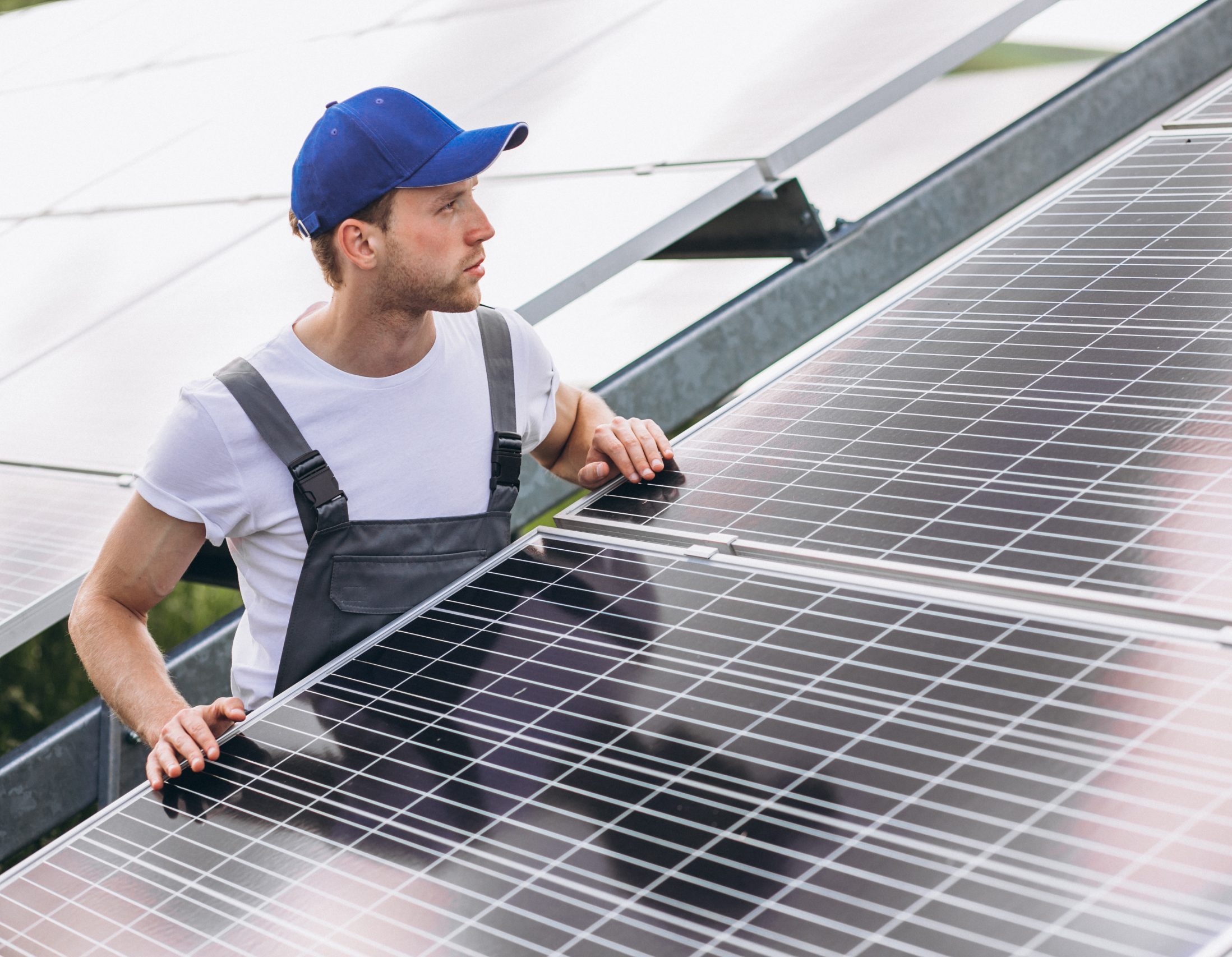 man worker firld by solar panels scaled e1717098371333